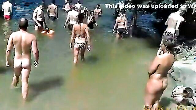 a group of nude individuals enjoying themselves at a lakeside camp : cmonahan