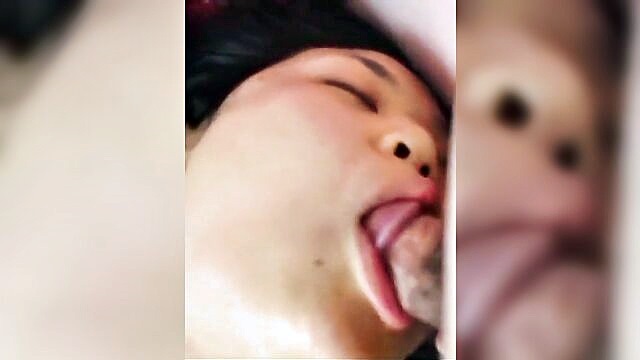 a korean man gives a blowjob while lying on a bed : greyson_kertzmann