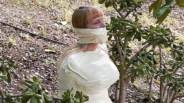 fetish, big tits, brunette - newly mummified and bound with microfoam tape in an erotic bdsm scenario