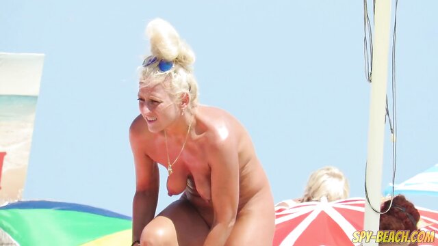 blonde milf gets naked on a public beach in hd video : Milf