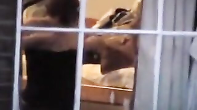 amateur porn featuring a woman changing in front of a window : delta97